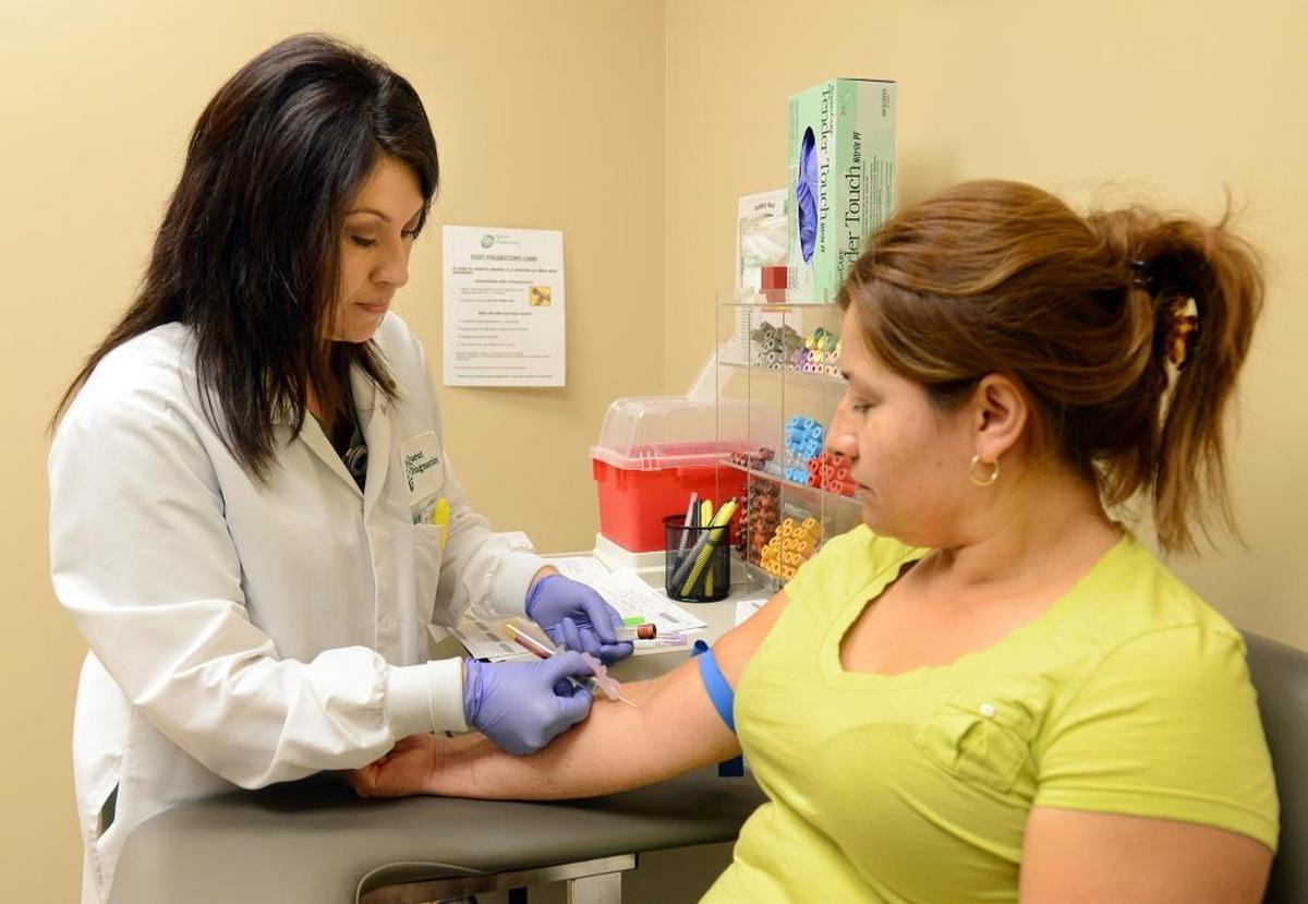 Susana Cervantes draws blood on patient Antonia Lopez of Fresno at Clinica Sierra Vista on Aug. 20, 2013. In Fresno, Clinica operates school-site clinics that serve children from low income families.