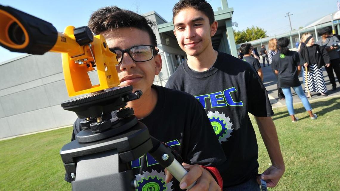 Career Technical Education Charter High students Rafael Medina, left, and Justin Lopez set up a line in their math class with a surveyor’s scope.