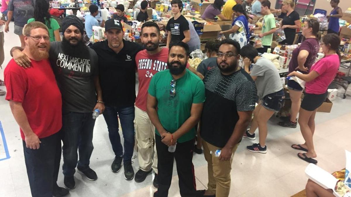 With their new-found buddy Jimmy, Manpreet Singh, Pastor Chris, Iqbal Bains, Varinder Malhi and Happy Singh regrouped at a donation-distribution center in Rosenberg, Texas.