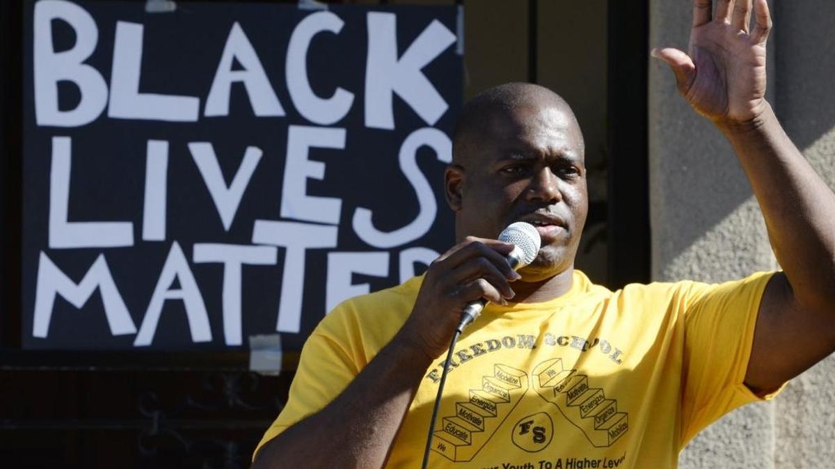 The Rev. Dr. Floyd Harris Jr. addresses those gathered at New Light For New Life Church of God for a rally in west Fresno in August.