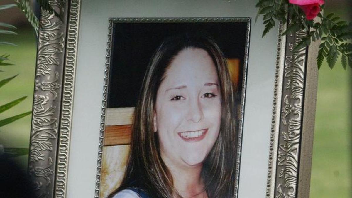 A photo of Sgt. Regina Reali of Fresno hangs at the graveside services at Belmont Memorial Park in Fresno in 2006. The Army reservist was killed in Iraq by a roadside bomb on Dec. 23, 2005.