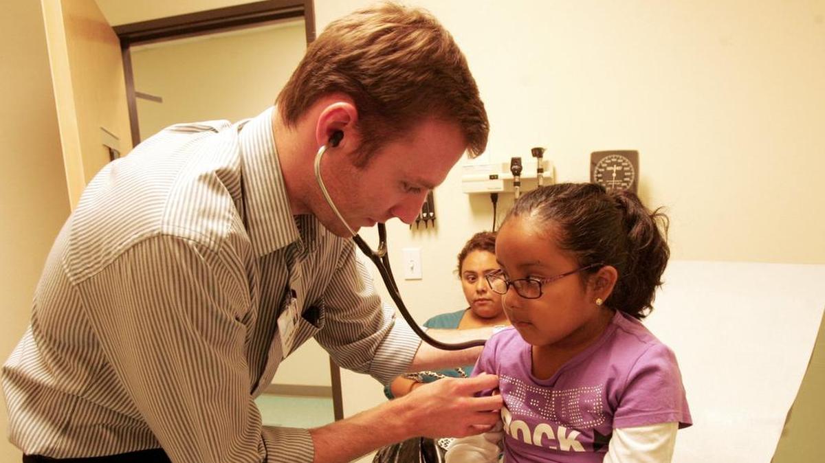 Physician assistant Adam Marks examines 4-year-old Azul Michelle Cruz to the Family Health Care Network in Cutler in this file photo. Azul’s mother, Edith Cruz, says her child was showing respiratory problems.