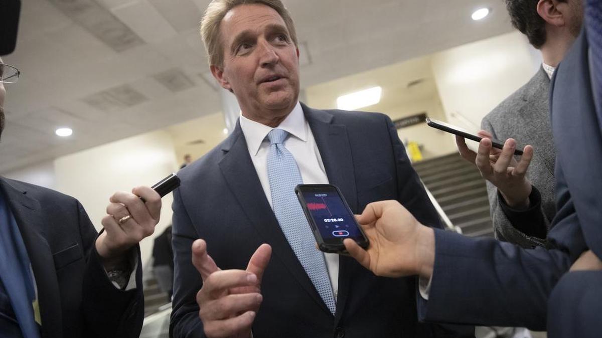 Sen. Jeff Flake, R-Ariz., speaks with reporters before he and Sen. Chris Coons, D-Del., try to bring up the legislation to protect special counsel Robert Mueller, at the Capitol in Washington, Wednesday, Nov. 14, 2018.