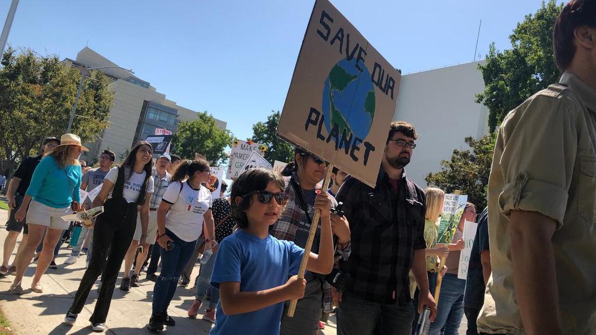 Michael Parkin, 8, marches in downtown Fresno on Friday, Sept. 20, 2019, as part of a worldwide strike for awareness on climate change.