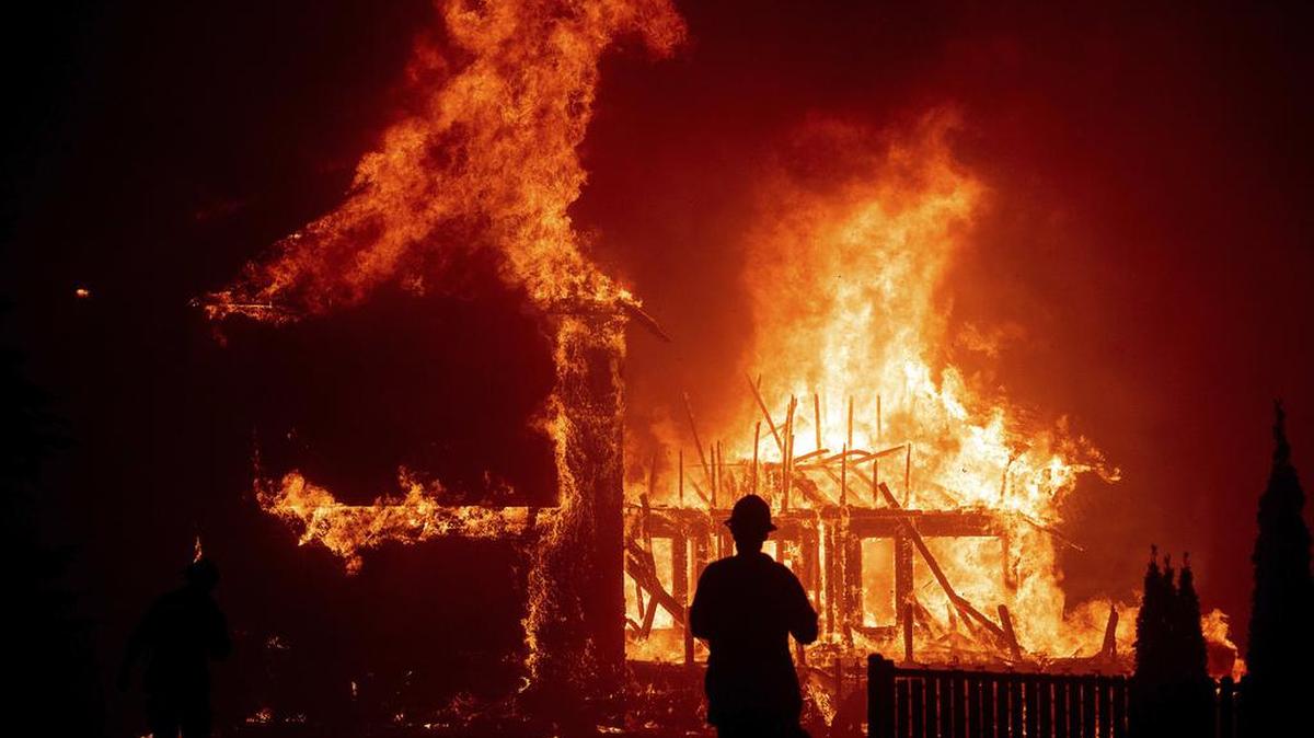 In this Nov. 8, 2018 photo, a home burns during a wildfire in Paradise. PG&E equipment was later found to have caused the blaze that leveled the town.