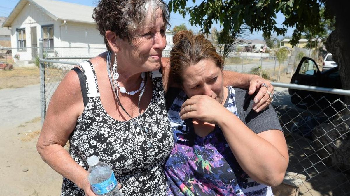 Donna Johnson, left, comforts Angelica Gallegos after Gallegos had bottled water delivered to her home on Conner Street in East Porterville in August 2014. Many residents of East Porterville still are getting no water or limited water from their wells because of the drought.