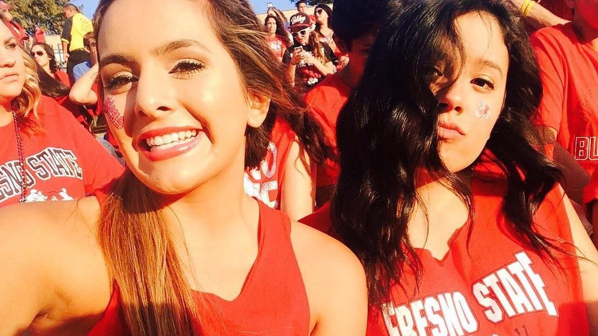 Gracie Guillen, left, shows support for Fresno State during a #WeAreFresnoState rally. President Joseph Castro says $24 million — the cost of one mile of the proposed border wall — could instead be used for an endowment that would pay full scholarships for 150 students a year.