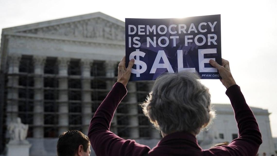 
People protest during oral arguments in the case of McCutcheon v. Federal Election Commission at the U.S. Supreme Court in Washington, D.C., Oct. 8, 2013. The case tested the Constitutional limits of campaign finance laws involving contributions to candidates and political parties and followed the 2010 Citizens United decision. 
