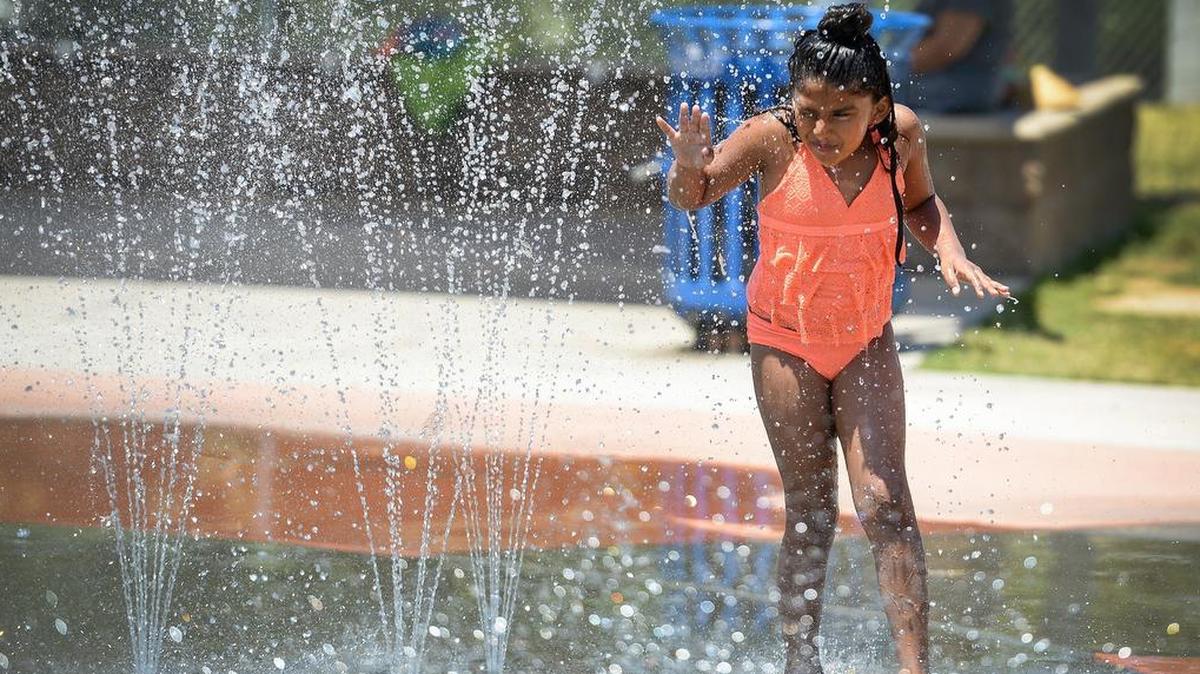 Dominique Mendoza, 8, of Fresno, cools off in the splash park at Inspiration Park in northwest Fresno as temperatures climbed toward triple digits one Saturday in June.