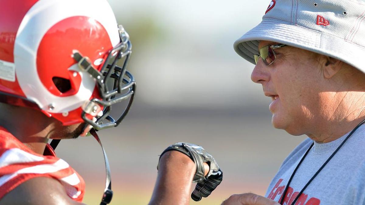 Fresno City under Tony Caviglia, at right, working with linebacker Tamarcus Russell on Aug. 11, 2016, has made a bowl game every year since he took over as coach in 1999. The Rams need to win their final two games to have a shot at extending that streak this year.