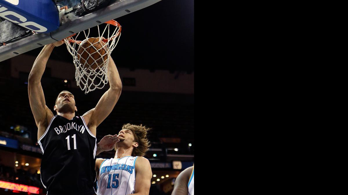 
Brooklyn Nets center Brook Lopez dunks over his brother Robin in 2013. The twins are testing free agency.
