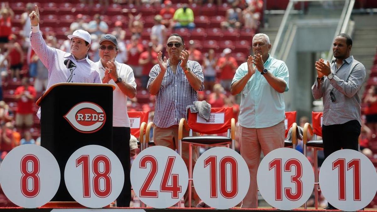 Baseball’s hit king, Pete Rose, left, gestures as the crowd cheers alongside Reds greats, from left to right, Johnny Bench, Tony Perez, Dave Concepcion and Barry Larkin during a ceremony to retire Rose’s No. 14 on Sunday, June 26, 2016, in Cincinnati.
