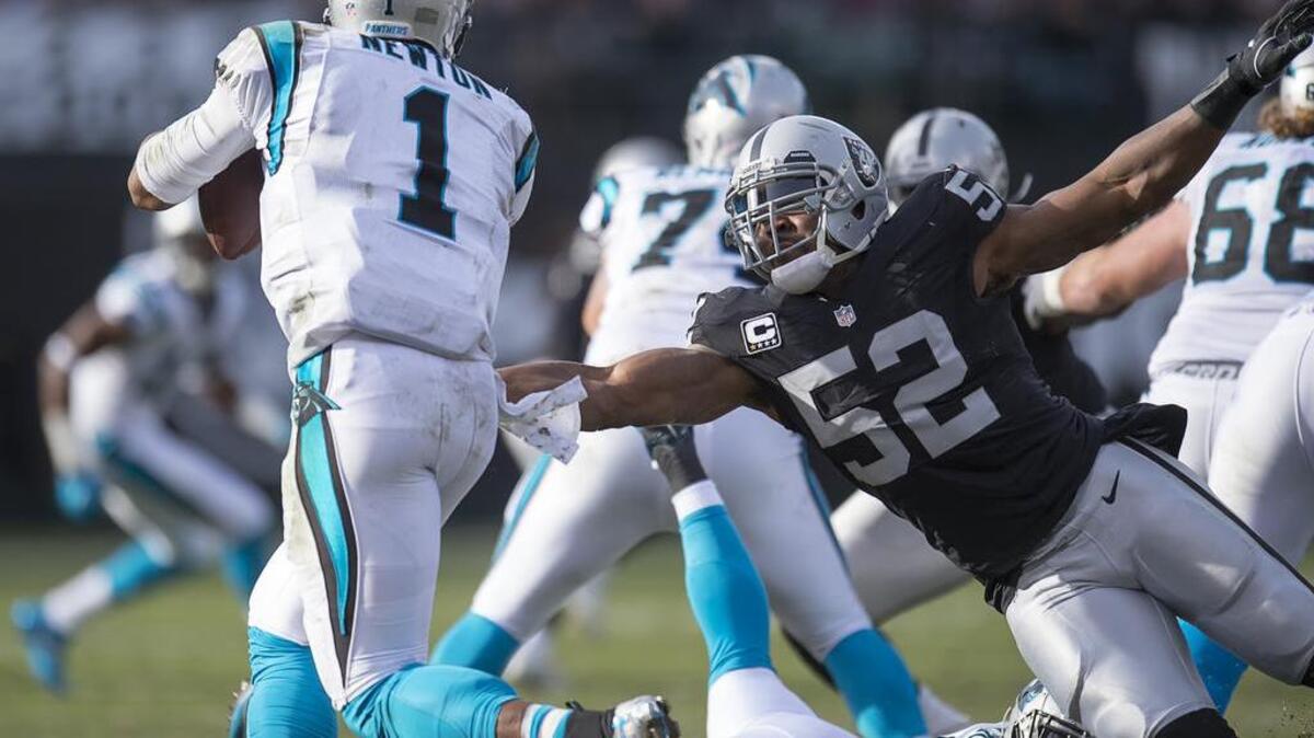 Oakland Raiders defensive end Khalil Mack (52) pressures Carolina Panthers quarterback Cam Newton (1) in the second quarter during an NFL football game, Sunday November 27, 2016 in Oakland.