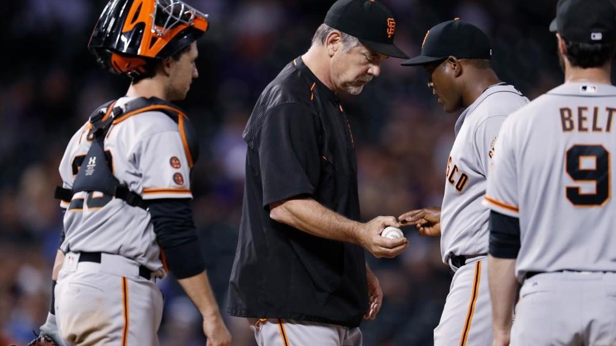 San Francisco Giants catcher Buster Posey, left, waits as manager Bruce Bochy takes the ball from relief pitcher Santiago Casilla, who had given up a single to the Colorado Rockies’ Tom Murphy in the ninth inning of a baseball game Wednesday, Sept. 7, 2016, in Denver. Giants first baseman Brandon Belt is at right. The Rockies won 6-5.