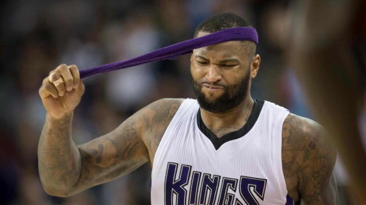 Sacramento Kings center DeMarcus Cousins (15) pulls off his head band after he fouled out in the Kings’ 129-128 double-overtime loss against the Charlotte Hornets on Jan. 25, 2016, at Sleep Train Arena in Sacramento.