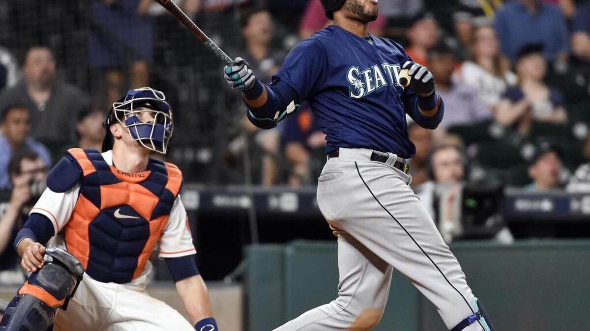 The Seattle Mariners’ Robinson Cano watches his go-ahead home run off Houston Astros relief pitcher Luke Gregerson in the 11th inning of a baseball game, Monday, Sept. 26, 2016, in Houston. The win kept the Mariners tied with the Tigers in the American League wild-card hunt.