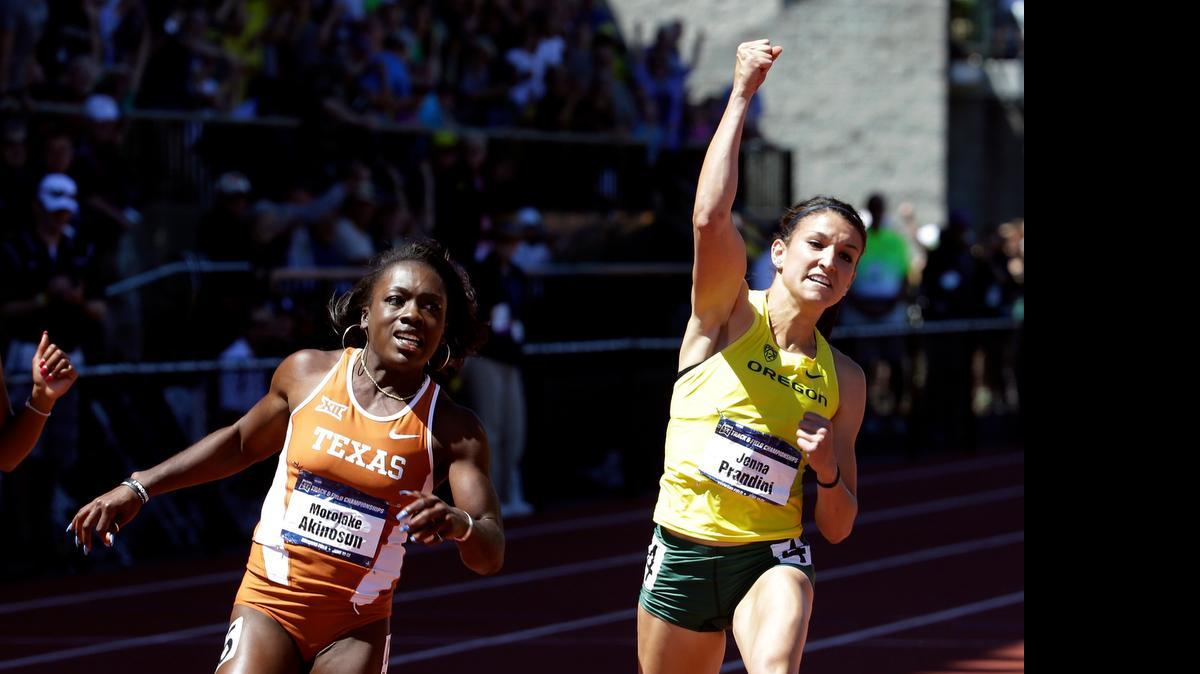 
Oregon’s Jenna Prandini celebrates winning the women’s 100 meters ahead of Texas’ Morolake Akinosun during the NCAA Championships on June 13, 2015, in Eugene, Oregon.
