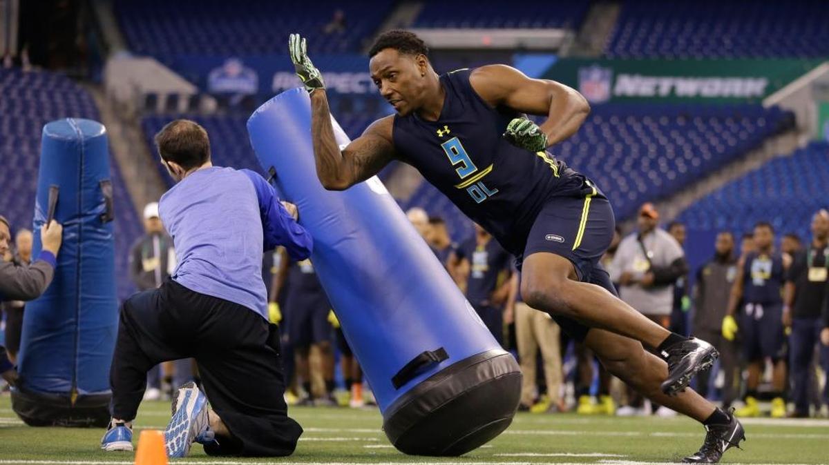 Michigan defensive end Taco Charlton runs a drill at the NFL football scouting combine in Indianapolis on March 5, 2017. The Fresno Grizzlies sent out an invitation to Charlton to a Fresno Tacos game.