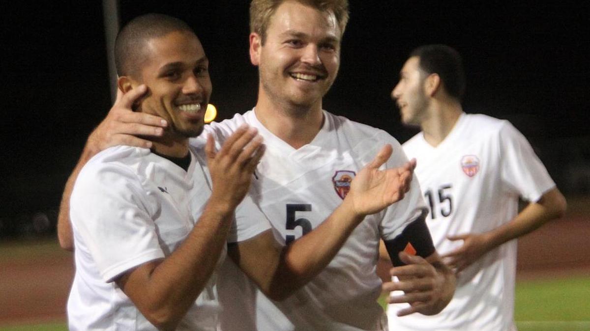 
Fresno Pacific soccer players celebrated a 2013 victory over Bethesda in the West Regional of the National Christian College Athletic Association playoffs, the Sunbirds’ lone national championship avenue while it completed a four-year transition to NCAA Division II status. Beginning with the 2015-16 school year, all of the university’s athletic programs, other than the suspended tennis teams, are eligible for NCAA postseason berths. 
