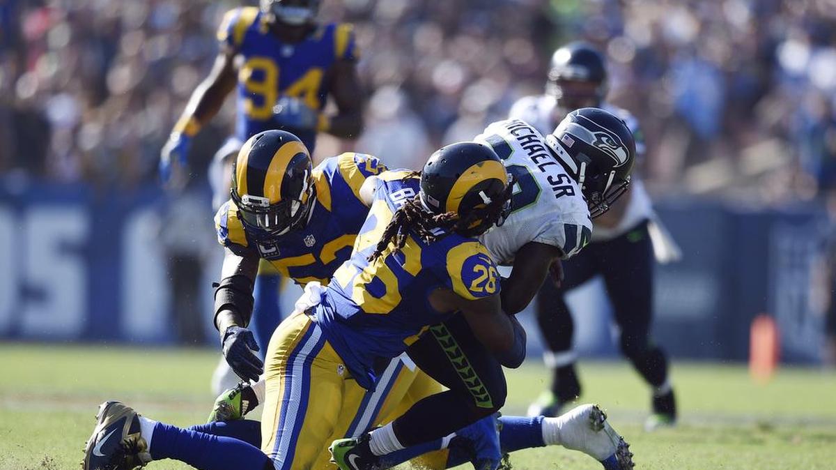 Seattle Seahawks running back Christine Michael, right, is tackled by Los Angeles Rams linebacker Mark Barron, center, and linebacker Alec Ogletree, left, before fumbling during an NFL football game, Sunday, Sept. 18, 2016, in Los Angeles. The Rams won 9-3.