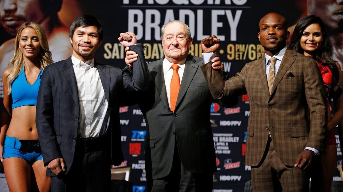 Promotor Bob Arum, center, holds up the arms of Manny Pacquiao, left, and Timothy Bradley during an April 6 appearance in Las Vegas ahead of Pacquiao-Bradley III at MGM Grand Garden Arena.