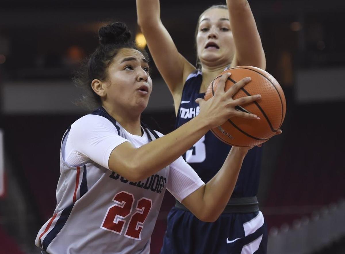 Fresno State’s Aly Gamez drives under Utah State’s Olivia West, on Wednesday, January 3, 2018, at Save Mart Center. Gamez scored a team-high 17 points in the Bulldogs’ 57-56 win.