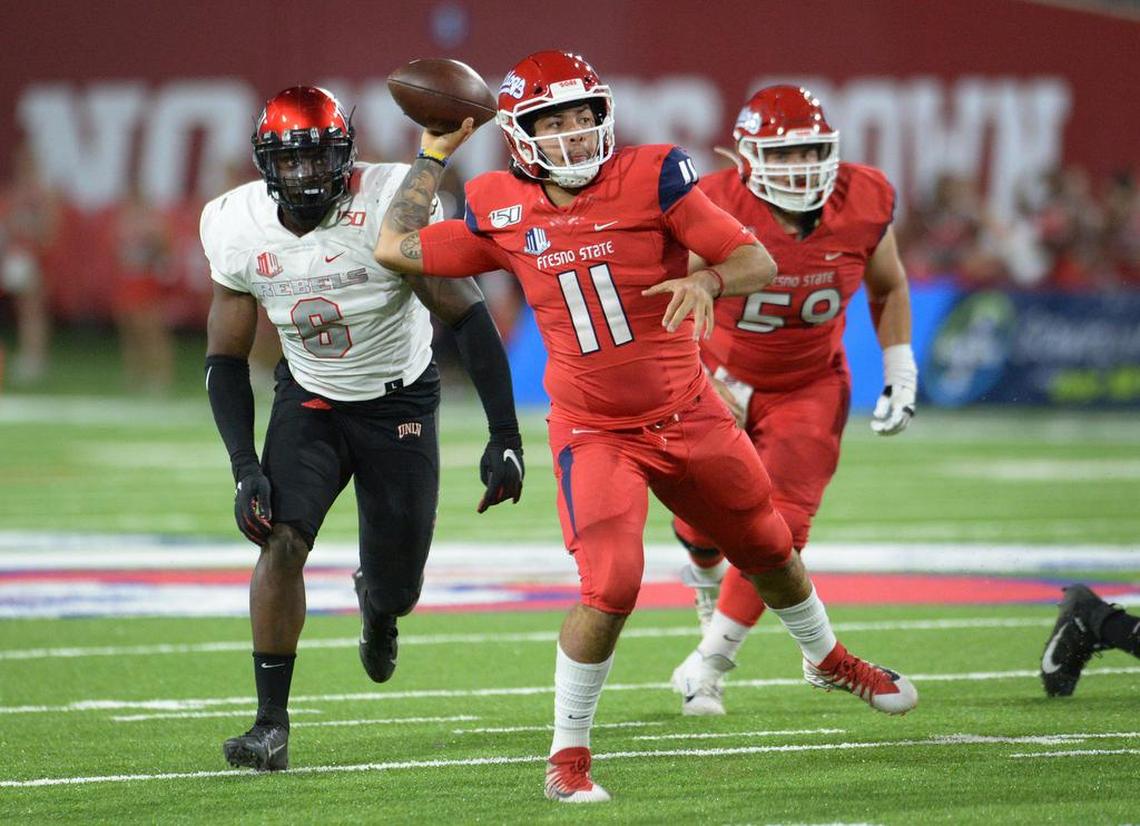 Fresno State quarterback Jorge Reyna throws after being forced out of the pocket by the UNLV defense during their game at Fresno State’s Bulldog Stadium on Friday, Oct. 18, 2019.