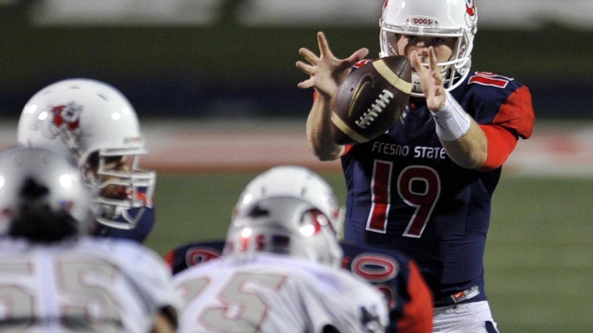 Fresno State quarterback Kilton Anderson, top right, takes a snap during the first half against UNLV on Friday, Oct. 16, 2015 in Fresno, Calif.