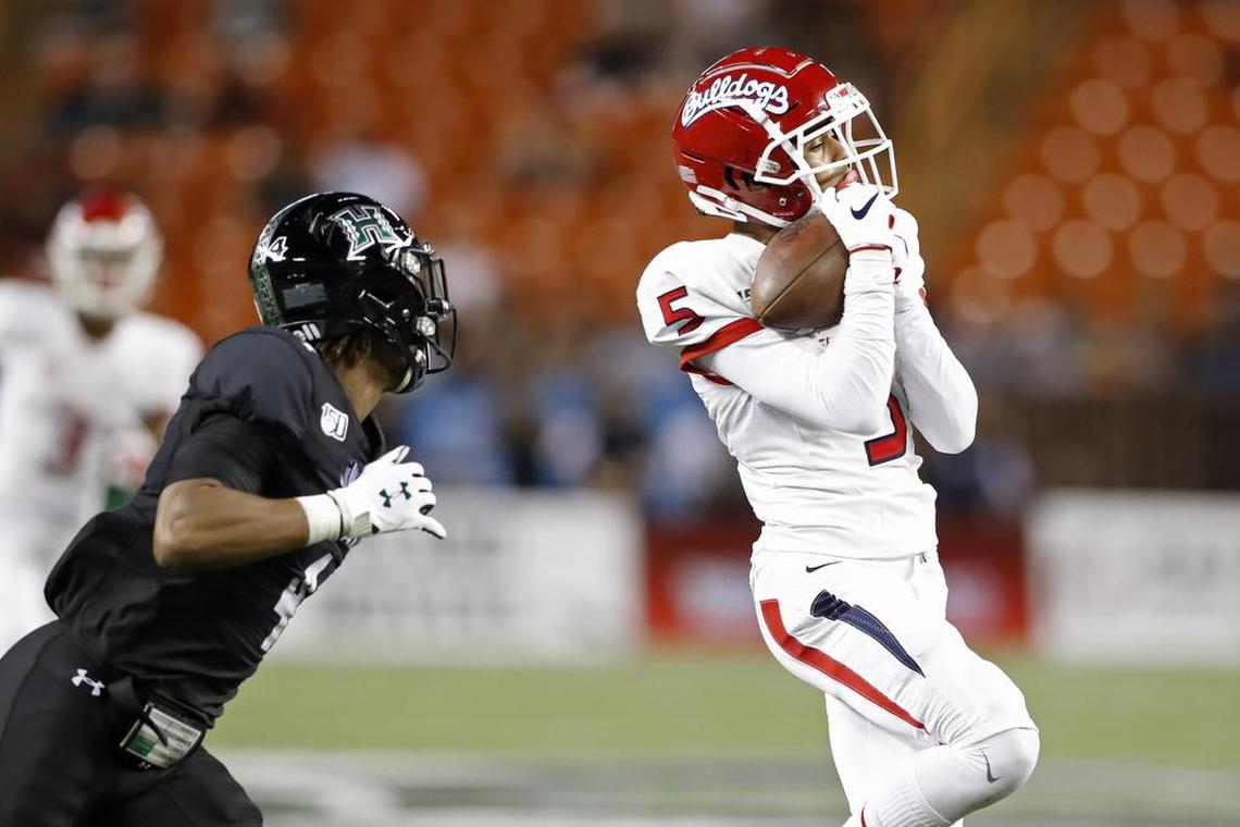 Fresno State wide receiver Jalen Cropper (5) pulls in a pass over Hawaii defensive back Rojesterman Farris II (4) in the Bulldogs’ 41-38 victory over the Rainbow Warriors Saturday, Nov. 2, 2019, in Honolulu.