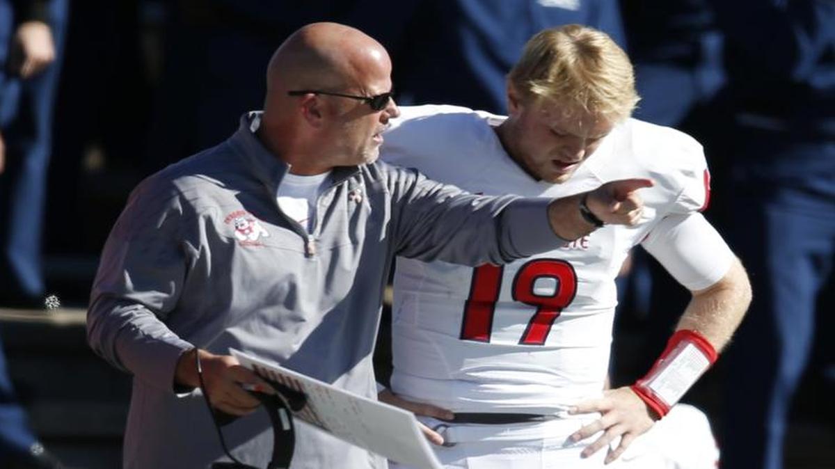 Fresno State offensive coordinator Dave Schramm, left, confers with quarterback Kilton Anderson during the second half of an Oct. 24, 2015, game in Colorado Springs. Anderson hit 14 of 39 passes (35.9 percent) in the 42-14 loss and is 43 of 91 (47.3 percent) overall this season.