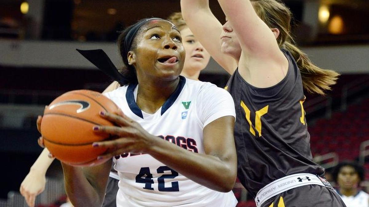 Fresno State’s Toni Smith, left, turns toward the hoop against Wyoming’s Natalie Baker on Wednesday, Feb. 17 at Save Mart Center. Smith went on to score a career-high 21 points as Fresno State won 65-52. She also was instrumental in the Bulldogs’ 67-61 win at Utah State over the weekend. As a result of her efforts, Smith was named the Mountain West’s player of the week Monday.