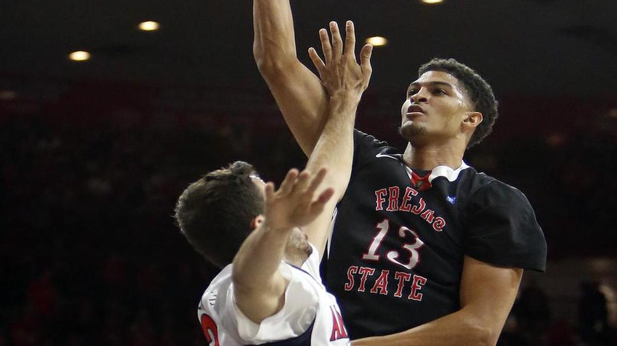 Fresno State forward Cullen Russo (13) shoots over Arizona forward Mark Tollefsen during the first half of an NCAA college basketball game, Wednesday, Dec. 9, 2015, in Tucson, Ariz.