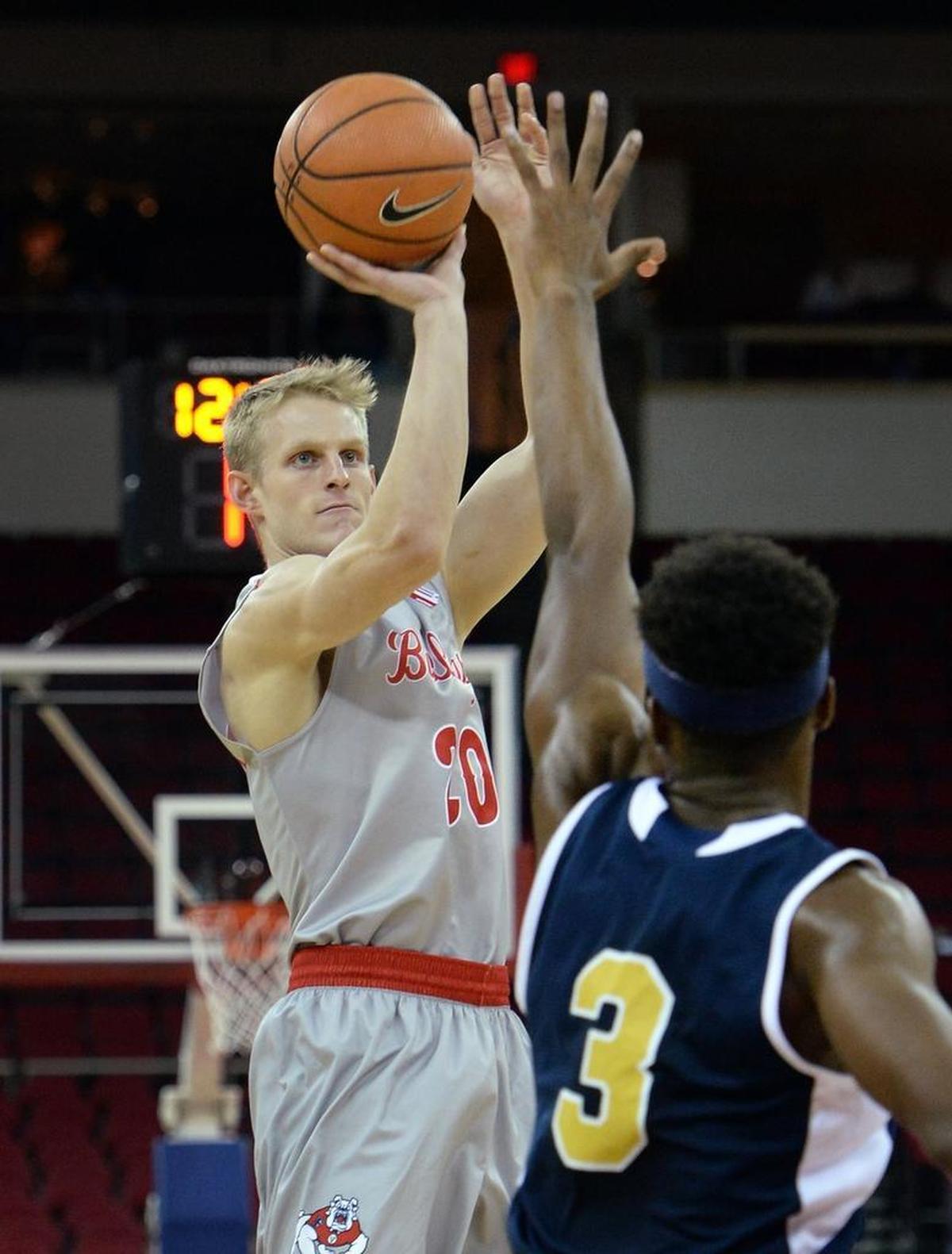 Fresno State forward Sam Bittner takes aim at a jump shot while defended by UC Merced’s Derek E’denchukwu during the first half of a 79-39 exhibition victory at the Save Mart Center on Friday, Nov. 3, 2017. Bittner has hit 21 of 32 shots from the 3-point line, 65.6 percent.