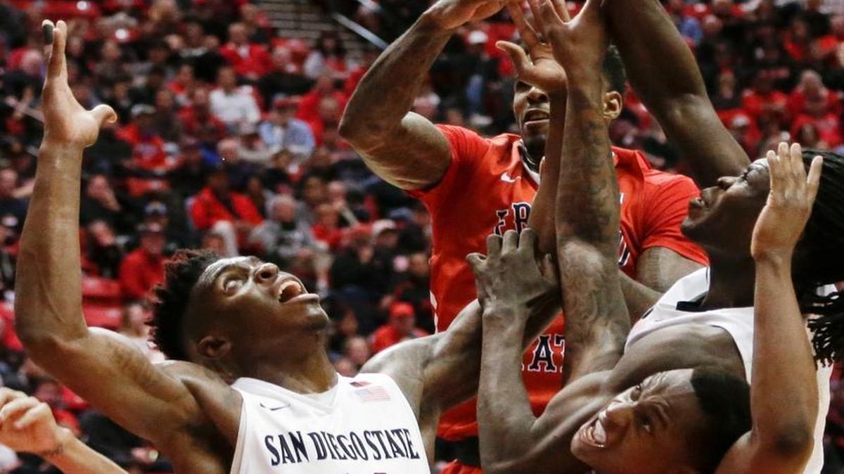 San Diego State forward Zylan Cheatham (14), Fresno State guard Marvelle Harris (23) and others battle for a rebound during the first half Tuesday, Jan. 19, 2016, in San Diego.