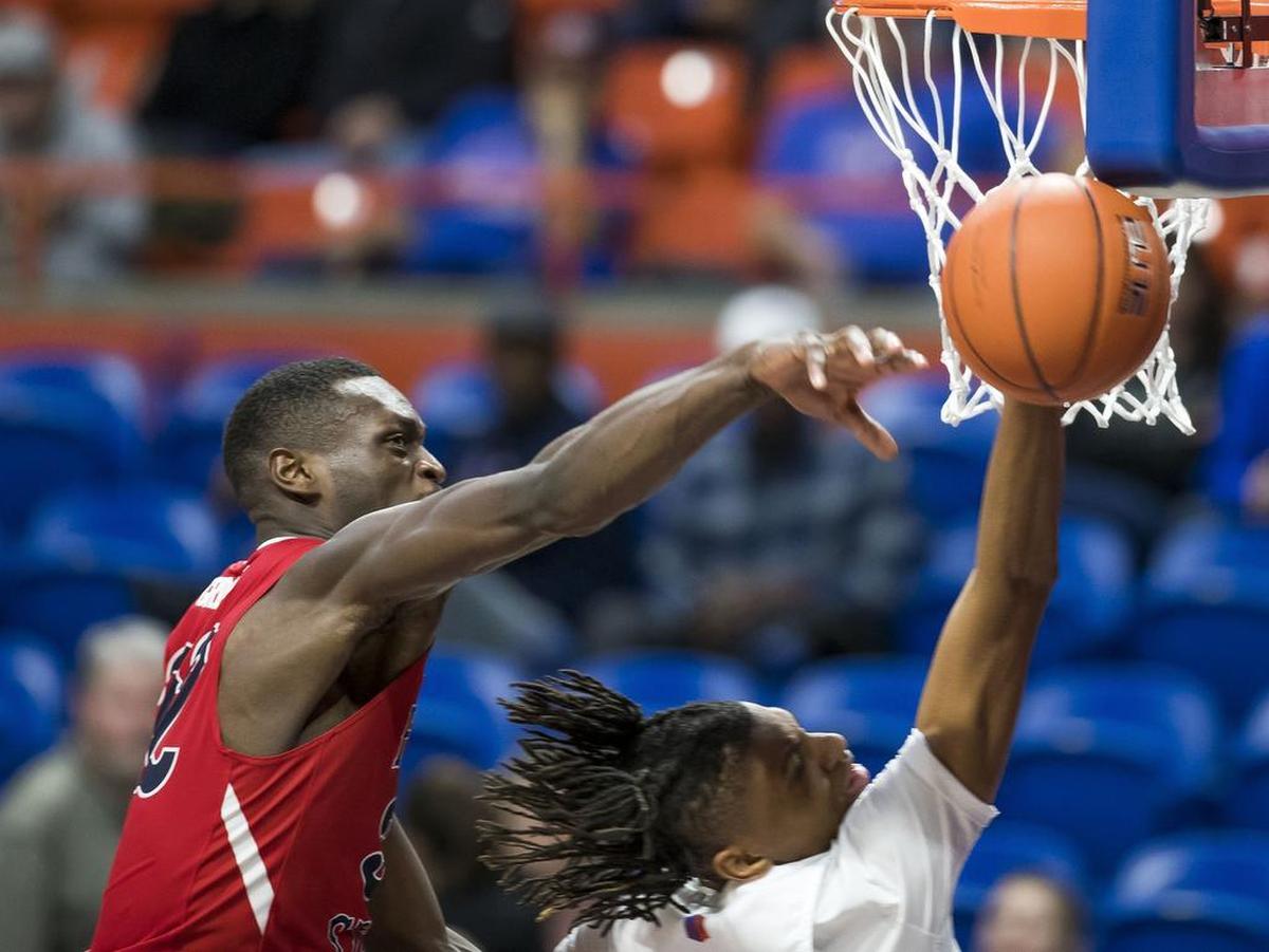 Fresno State forward Nate Grimes swats away driving shot by Boise State’s Derrick Alston in the second half Saturday, Jan. 19, 2019 at Taco Bell Arena in Boise.
