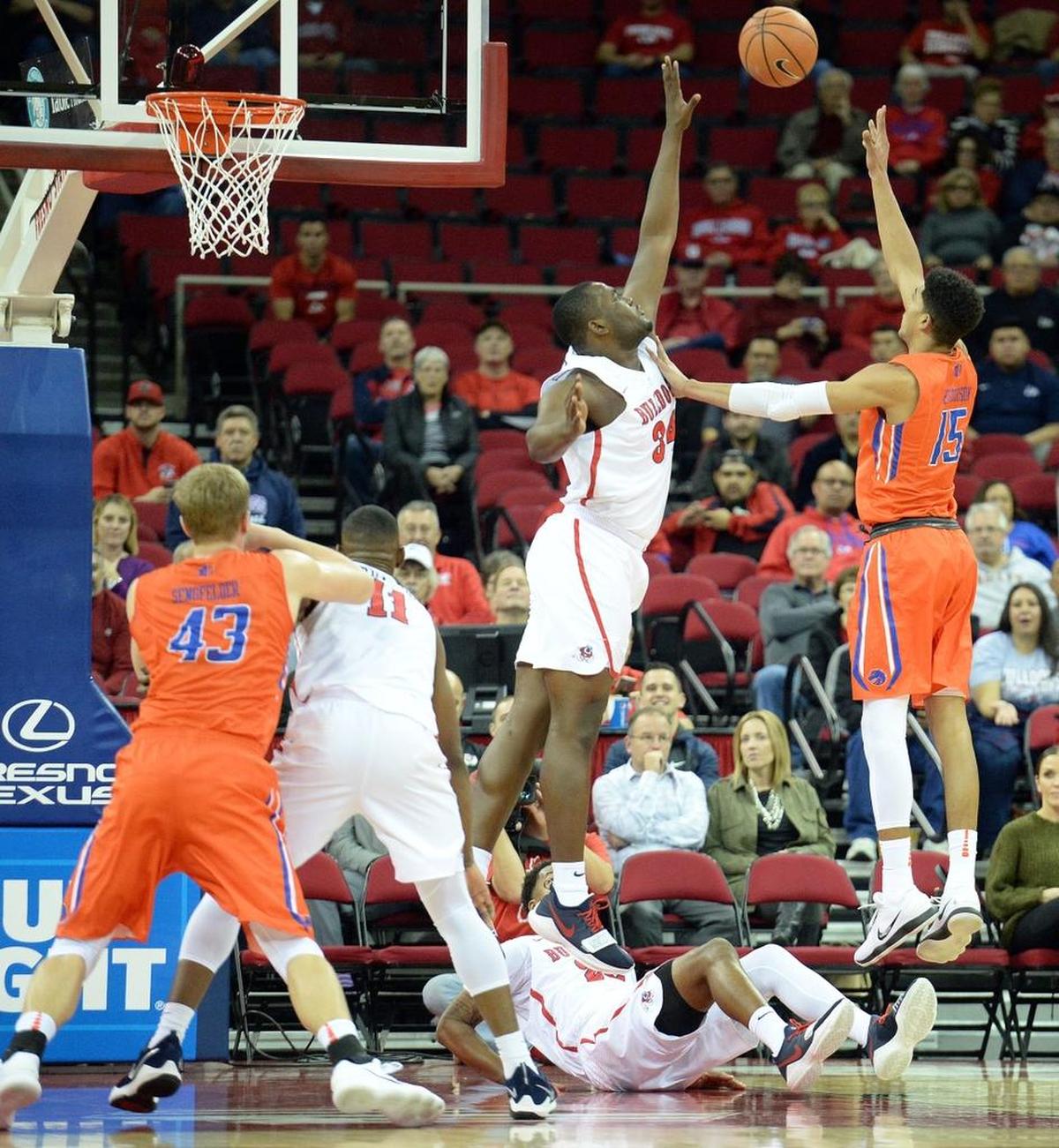 Fresno State center Terrell Carter II, center, tries to block a shot by Boise State’s Chandler Hutchison, right, during the Bulldogs’ 70-64 loss at the Save Mart Center in Fresno on Tuesday, Jan. 9, 2018. Hutchison led the Broncos with a game-high 21 points.
