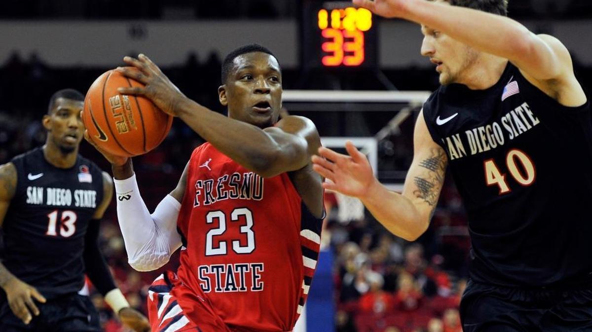 
Fresno State guard Marvelle Harris drives to the basket before being fouled by San Diego State’s Matt Shrigley in a January 20154 game at the Save Mart Center. Fresno State beat the then-No. 25 Aztecs 59-57, though San Diego State did go on to win a share of the Mountain West Conference regular-season championship.

