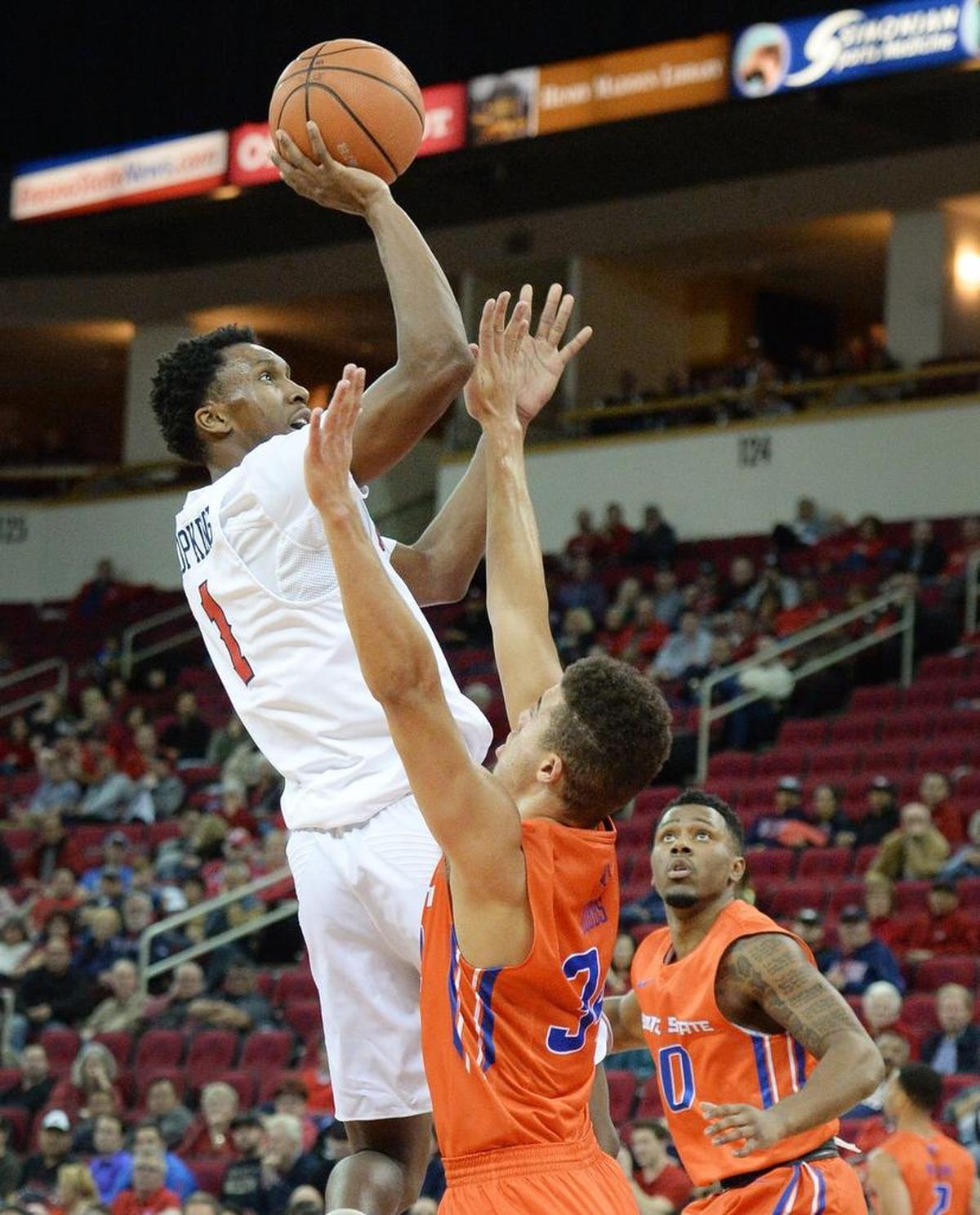 Fresno State point guard Jaron Hopkins gets a shot up over Boise State’s Justinian Jessup in the Bulldogs’ 70-64 loss at the Save Mart Center in Fresno on Tuesday, Jan. 9, 2018. Hopkins hit 5 of 7 shots in scoring 11 points with six rebounds and five assists in the loss.