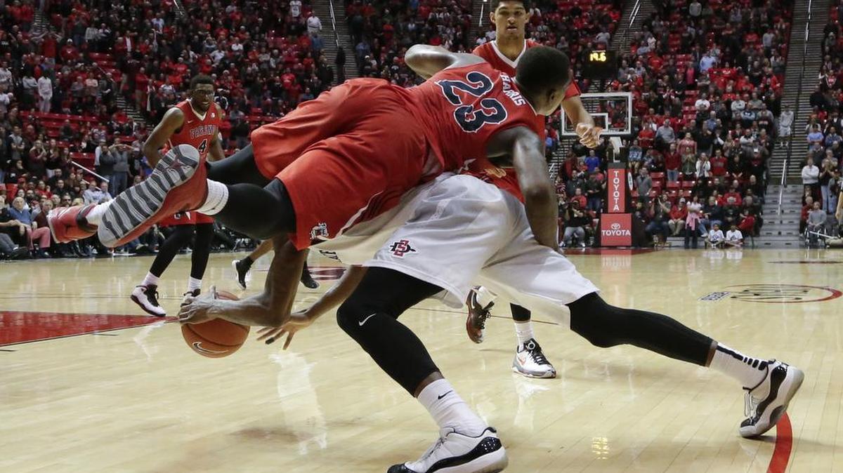 Fresno State guard Marvelle Harris fouls San Diego State forward Zylan Cheatham during the second half of Tuesday’s Mountain West Conference game. Cheatham finished 5 for 8 from the free-throw line and the Aztecs were 22 of 36 overall, including 13 of 16 in overtime of their 73-67 victory.