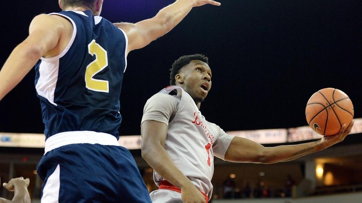 Fresno State guard Jaron Hopkins makes a move around UC Merced’s Aaron Laflin while going to the hoop during the first half of their exhibition game at the Save Mart Center on Friday, Nov. 3, 2017. Hopkins scored eight points with five rebounds and two assists in the Bulldogs’ 79-39 victory.