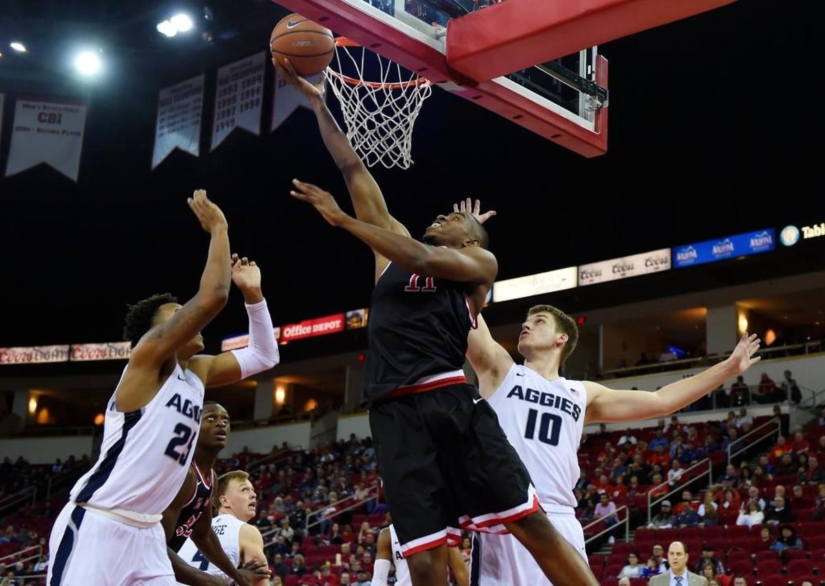 Fresno State forward Bryson Williams, center, scores on a layup between Utah State’s Dwayne Brown, Jr., left, and Quinn Taylor, right, in a 65-62 loss to the Aggies on Saturday, Jan. 27, 2018 at the Save Mart Center in Fresno. Williams is averaging 13.3 points and 6.0 rebounds in his sophomore season.