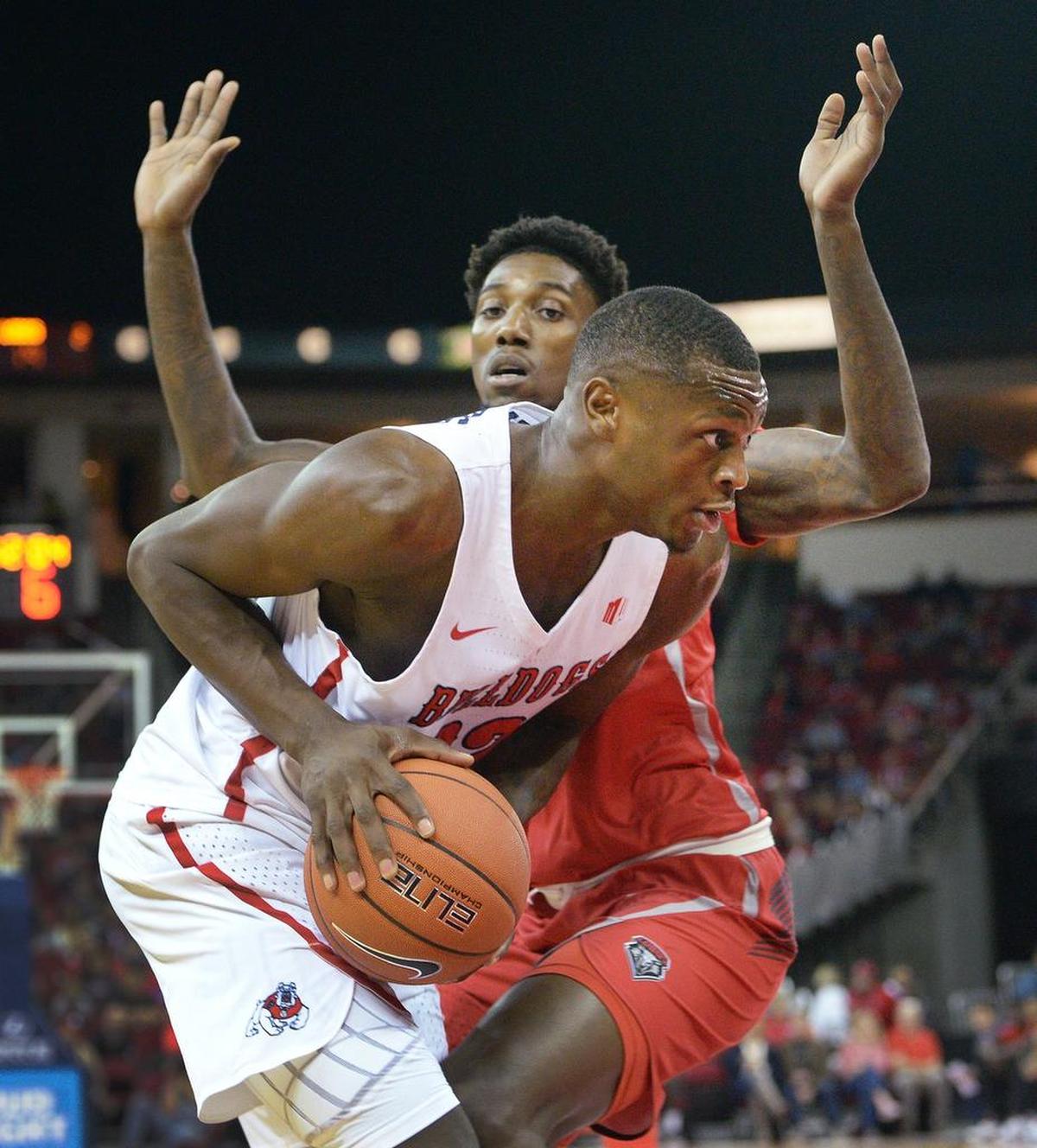 Fresno State’s Nate Grimes prepares to go to the hoop with New Mexico’s Corey Manigault defending during their game at the Save Mart Center in Fresno on Saturday, Feb. 2, 2019.