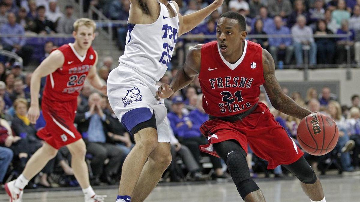 Fresno State guard Deshon Taylor (21) cuts around TCU guard Alex Robinson (25) during the first half of an NCAA college basketball game in the NIT, in Fort Worth, Texas, Wednesday, March 15, 2017.