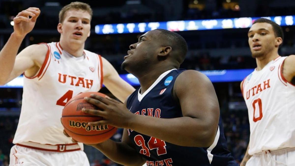 Utah’s Jakob Poeltl, left, and Brekkott Chapman cut off Fresno State’s Terrell Carter on the baseline in the first half of Thursday’s NCAA Tournament game.