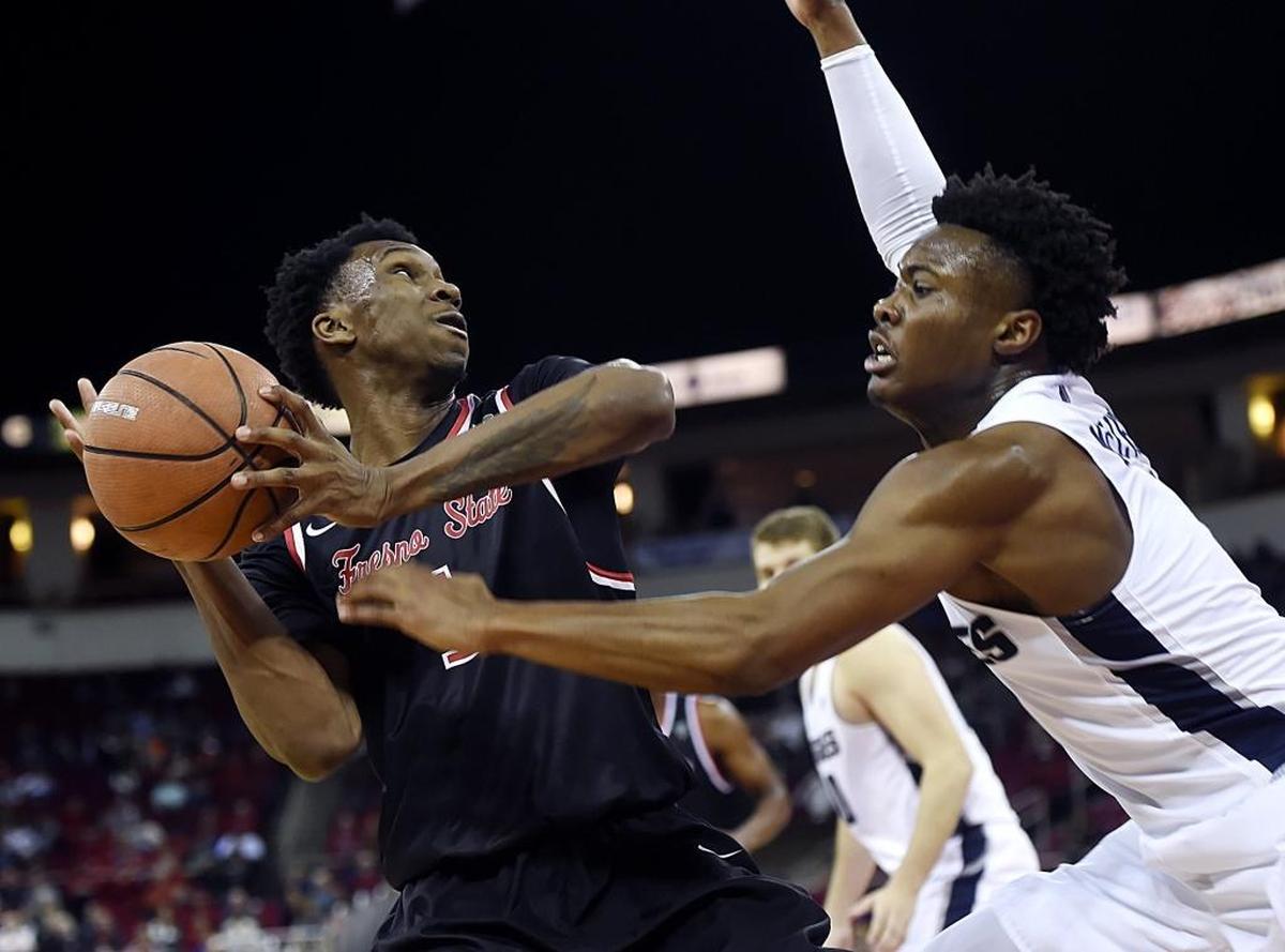 Utah State guard Koby McEwen, right, knocks the ball loose from Fresno State point guard Jaron Hopkins, left, in the Bulldogs’ 65-62 loss to the Aggies Saturday, Jan. 27, 2018 at the Save Mart Center in Fresno. Hopkins had a double-double in the loss with 11 points and 11 rebounds, as well as a team-high four assists.