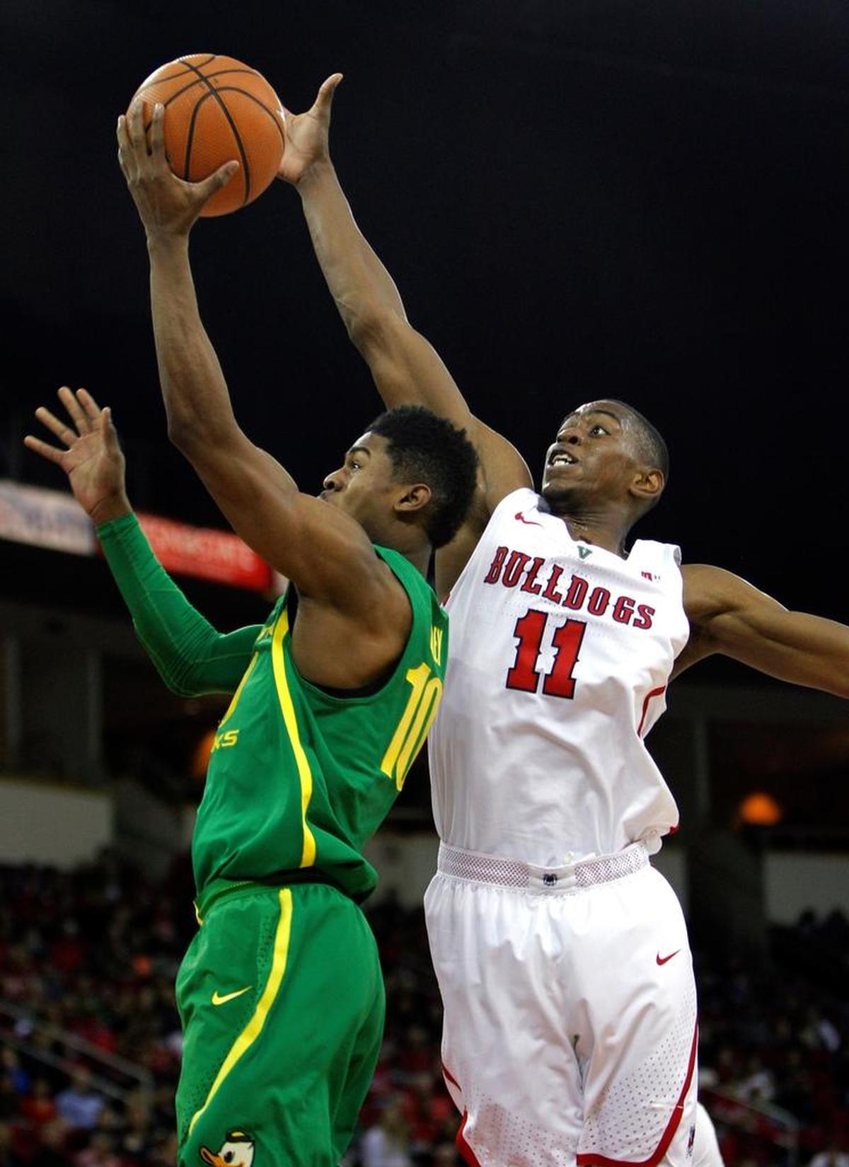 Fresno State forward Bryson Williams (11) swats away a shot by Oregon's Victor Bailey Jr. during the Bulldogs’ 68-61 loss in Fresno, Saturday, Dec. 16, 2017. Williams is averaging 12.7 points and 6.8 rebounds per game for the Bulldogs.