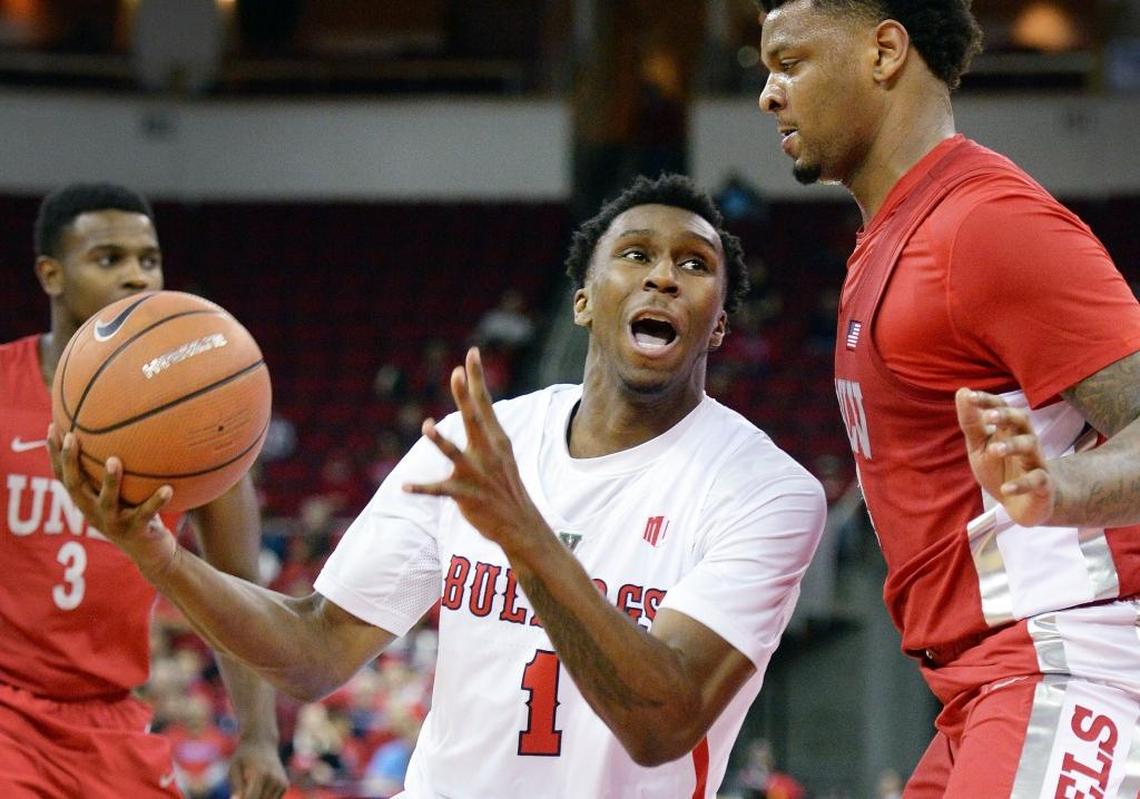 Fresno State’s Jaron Hopkins, center, works against UNLV’s Tervell Beck in the first half of their game at the Save Mart Center in Fresno, Calif. on Tuesday, Jan. 23, 2018.