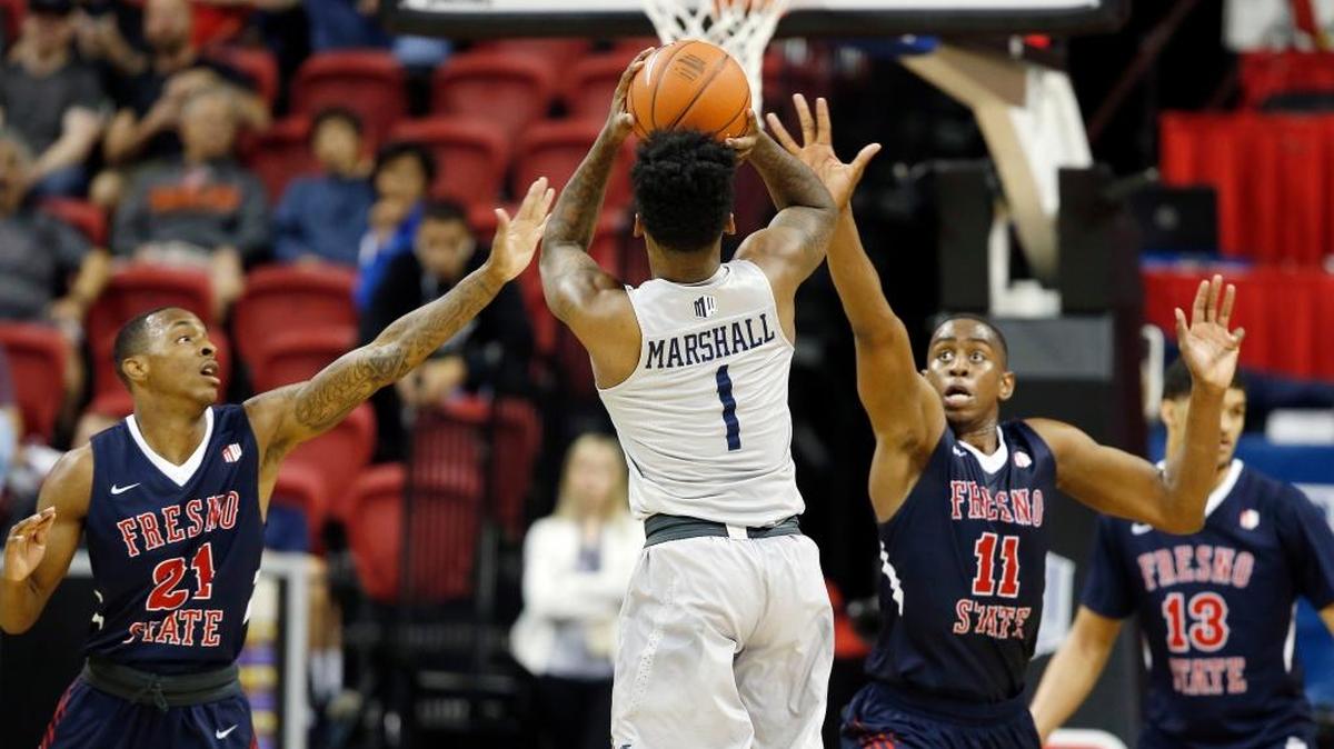 Nevada’s Marcus Marshall, center, shoots as Fresno State’s Deshon Taylor, left, and Bryson Williams defend during the second half of the Mountain West Conference tournament semifinals Friday, March 10, 2017, in Las Vegas. Nevada defeated Fresno State 83-72.