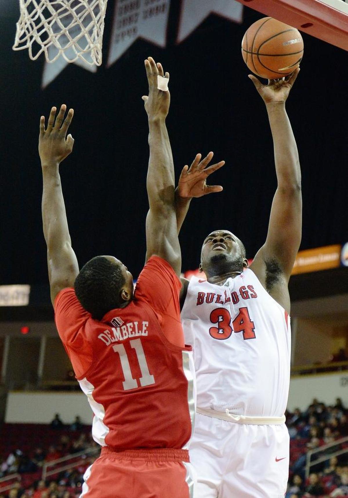 Fresno State center Terrell Carter II, right, scores against UNLV's Cheickna Dembele during the Bulldogs’ 69-63 victory over the Rebels at the Save Mart Center in Fresno on Tuesday, Jan. 23, 2018. Carter hit 8 of 12 shots in scoring 18 points.