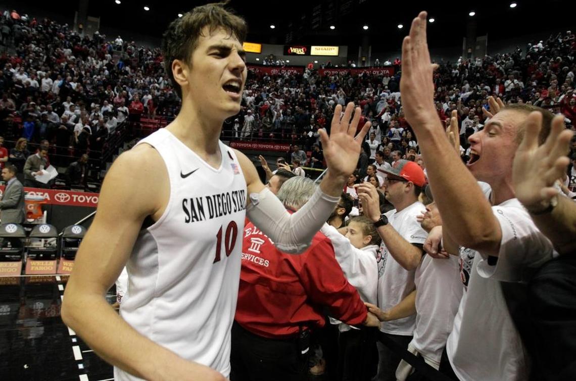 San Diego State’s Max Montana celebrates with fans after a 72-70 win against Gonzaga at Viejas Arena in San Diego on Dec. 21. The Aztecs are leading the Mountain West Conference in attendance, averaging 11,360, more than double Fresno State. The Bulldogs average 5,600 in home attendance.